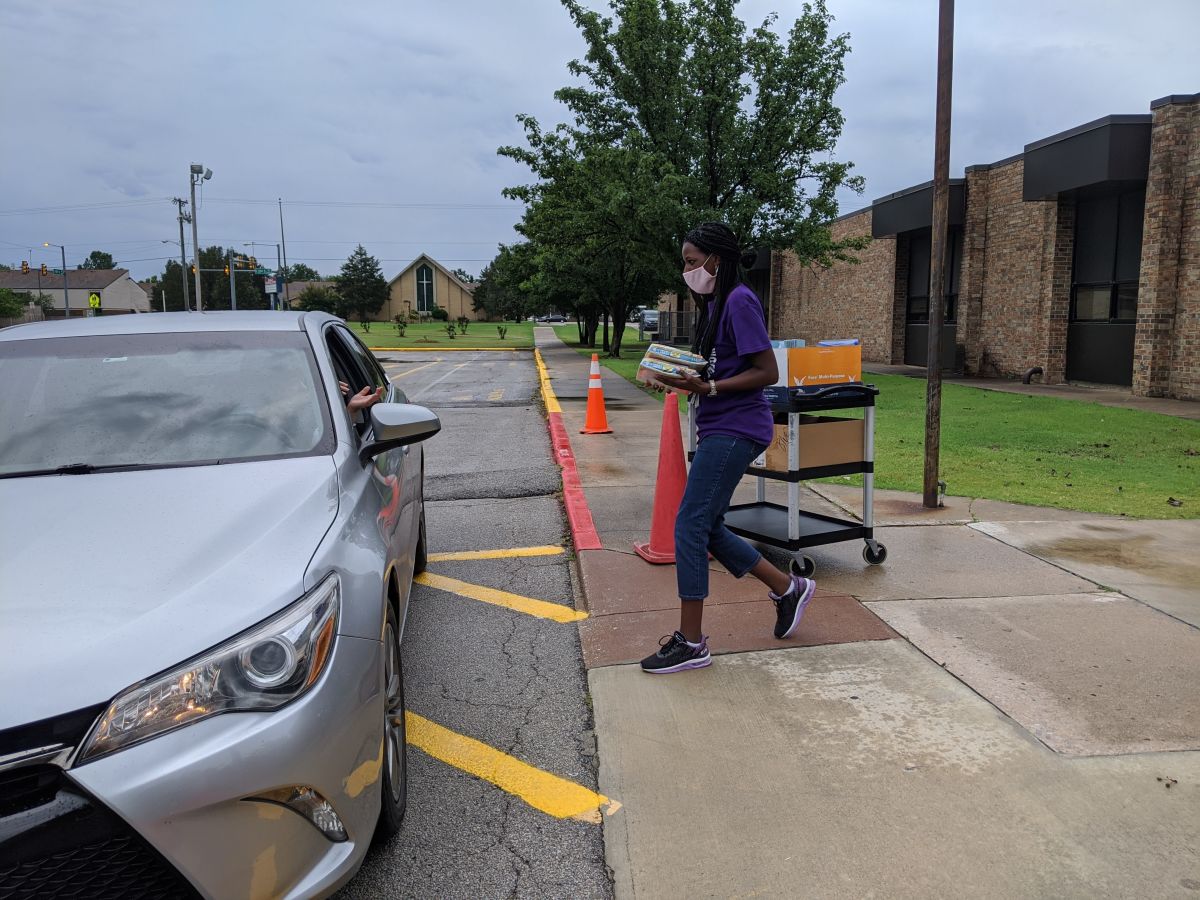 Before/After Care Team Hands Out Activity Packets for Students News