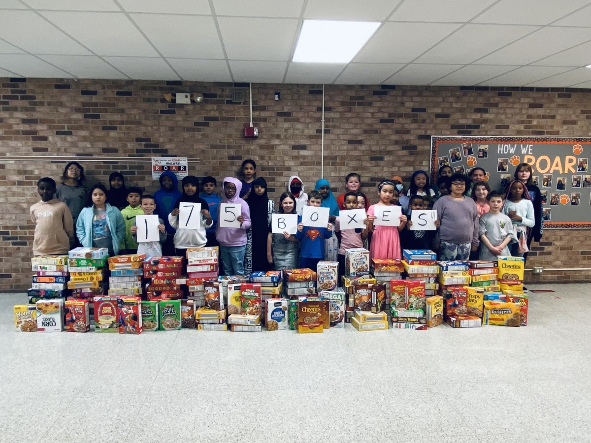 Schoolwide service project turns cereal boxes into dominos, helps hunger relief efforts in
