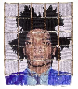 portrait of a young, African-American man wearing a blue suit created out of beadwork