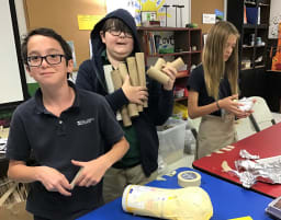 kids holding paper towel tubes