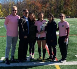 John and Sun-Min Han with family at Austin Prep girls soccer Senior Day event