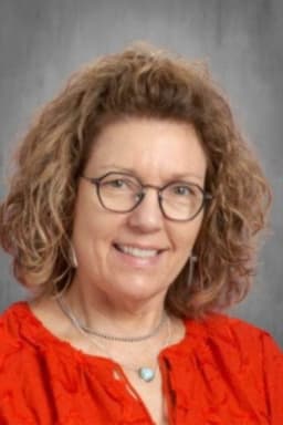 woman with glasses smiling