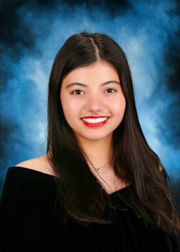 The image shows a young woman with long dark hair and a bright, friendly smile against a blue background.