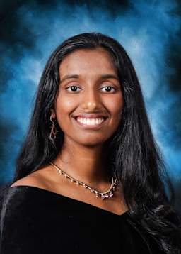 A young woman with long, dark hair and a warm, friendly smile is the focal point of the image, set against a vibrant blue background.