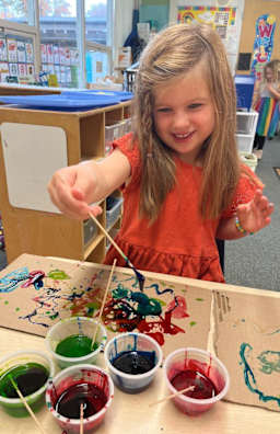 Girl smiling while painting