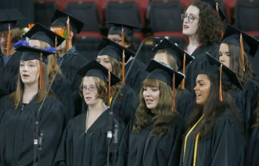 students singing at graduation