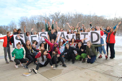 Group of AVID students with an AVID sign
