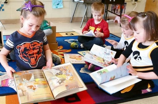 kids reading books on the floor