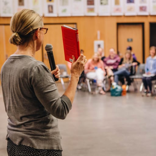 close-up shot of female instructor standing n front of classroom 