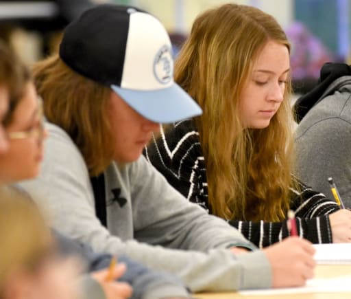 Two students listening during a lecture in class.
