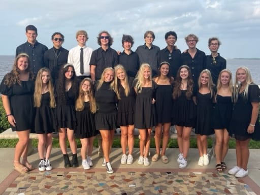 group of teenagers in group standing in front of river