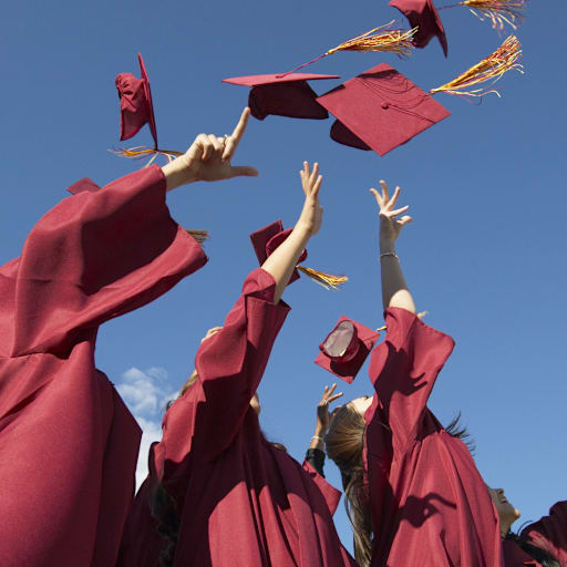 graduates toss caps