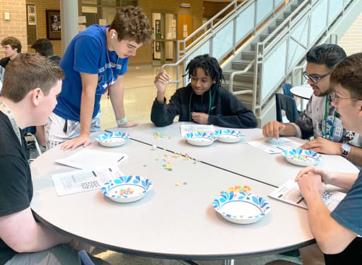 students do activity with fruit loops