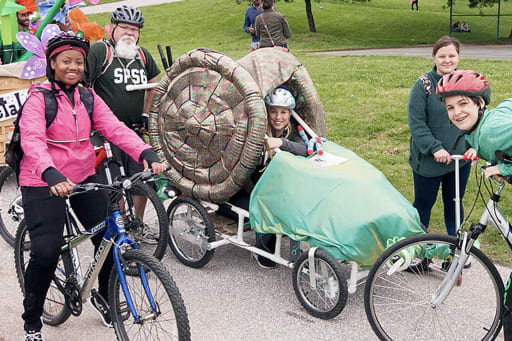 An instructor and group of students on bikes for the Kinetic Sculpture Race