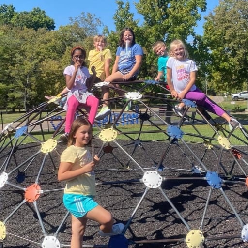 girls on jungle gym equipment on playground