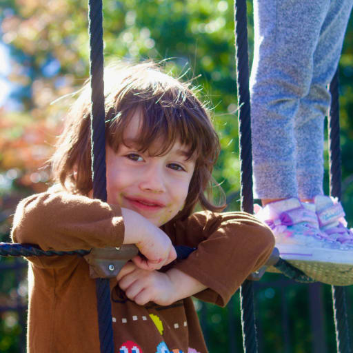 Pre-K boy climbing ladder