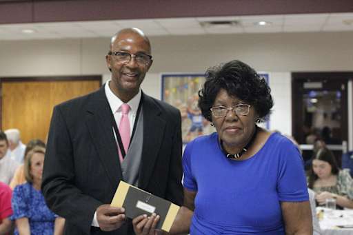 Human Resources Director Phillip Tremble presents a gift to Bus Driver Betty Tremble, who was recognized for 13 years of service.