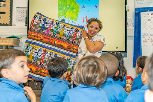 Teacher Discussing Different Hair Styles and Skin Colors with Students