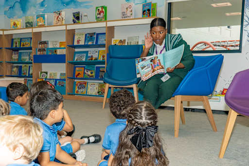 Students Listening to Denis Wallace Read a Story Book