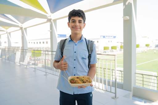 Student Posing with Carribean Food for Carribean Week