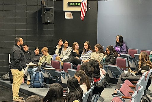 Man stands in front of students seated 