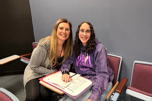 Two women seated side by side
