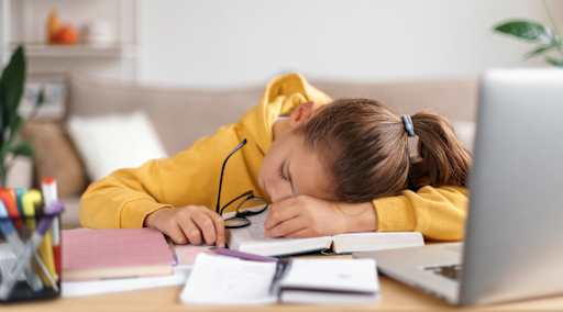 child sleeping at desk
