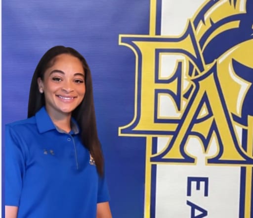 Coach Kacey Elphage against blue background with EA logo
