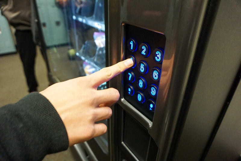 A student inputs their student ID in a vending machine.