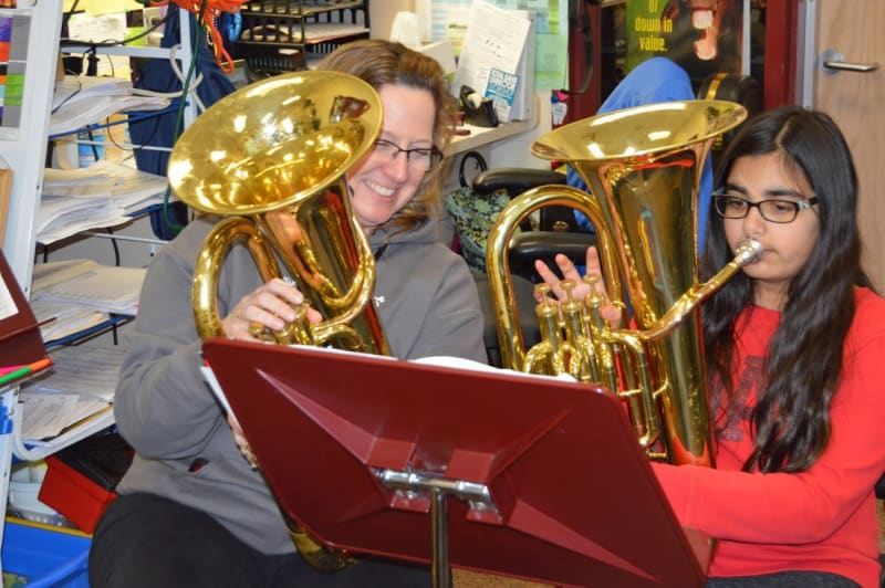 GH student with teacher playing brass
