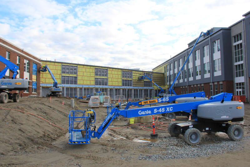 View looking east into the west courtyard, with the commons linking the north and south wings of the new HHS.