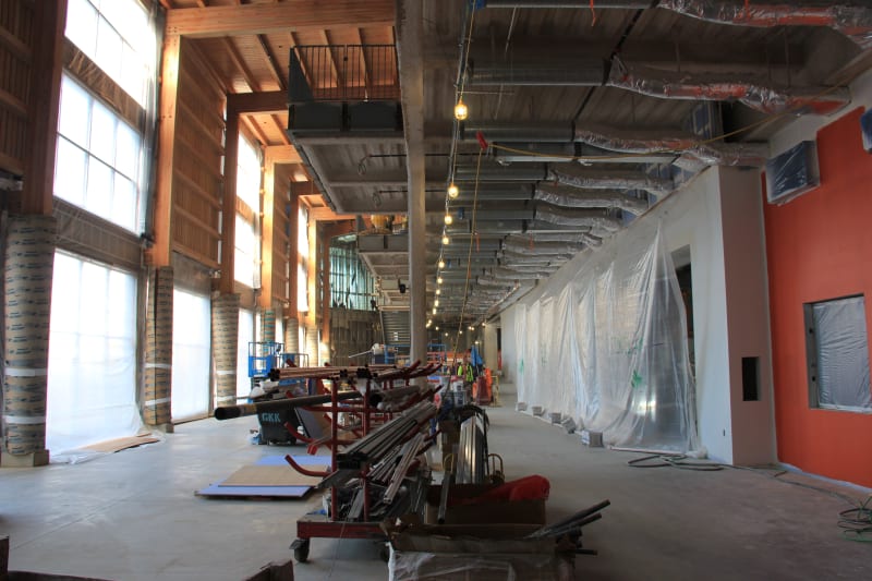 Looking north toward the main entrance down the commons, with the kitchen on the right and south courtyard to the left.