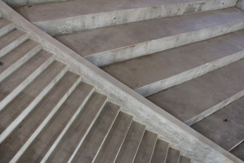 View of stairs leading up to library on the  second floor of the  commons, adjacent to a learning stair for students to sit,