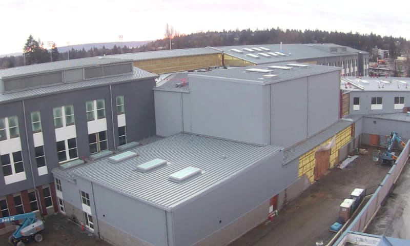 View of music rooms and theater in the foreground connected to the south wing on the left and the commons on the right.