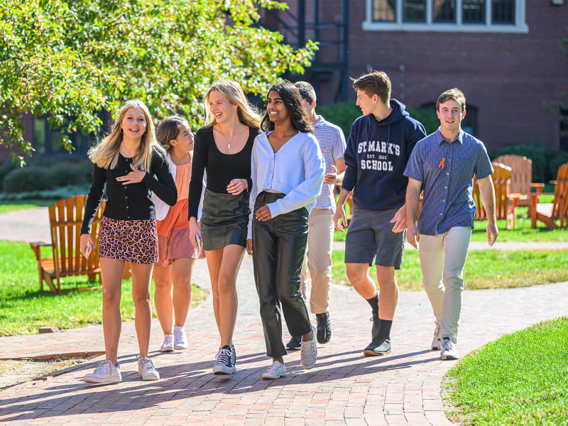 Students walk through the athletic quad on a sunny fall day.