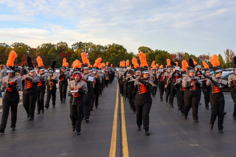 high school marching band marches in homecoming parade
