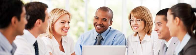 A group of four adults discussing committee information