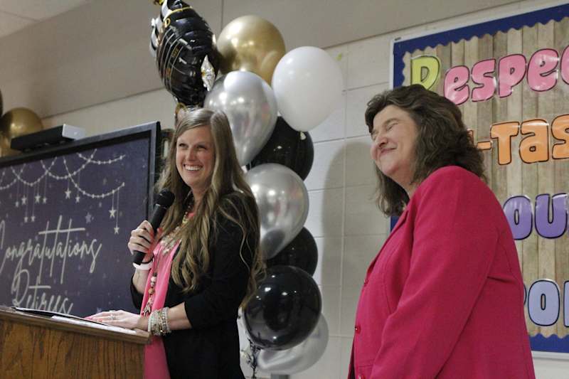 Chief Human Resources Officer Alli Baxter recognizes BJ Brannen, who is retiring with 28 years of service as the school district's employee benefits coordinator.
