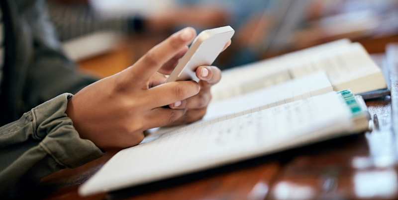 photo of a student's hand holding a cellphone
