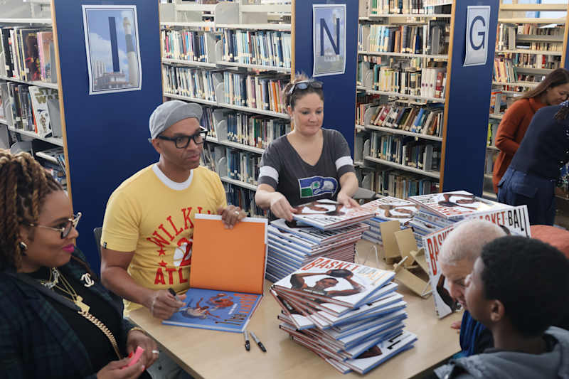 Kadir Nelson signs books for students.