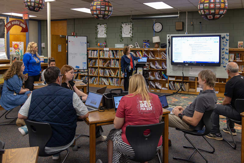 Small cohort of teachers meeting in the Huntersville Elementary School library media center during a lesson planning workshop.