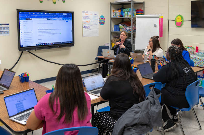 Teachers gathered around a workspace table working collaboratively during a professional development track session at Winget Park.