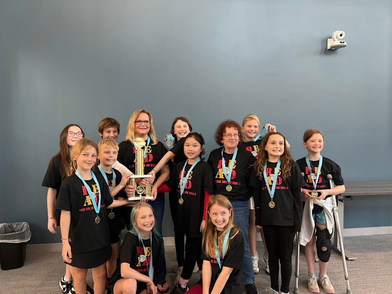 Bellamy Elementary Battle of the Books team celebrating with their trophy