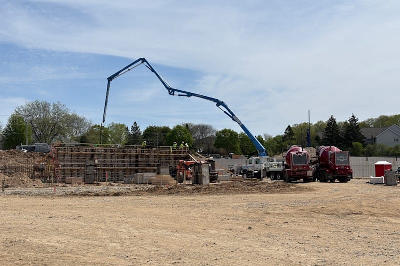 Retaining walls being built with a concrete pump truck.