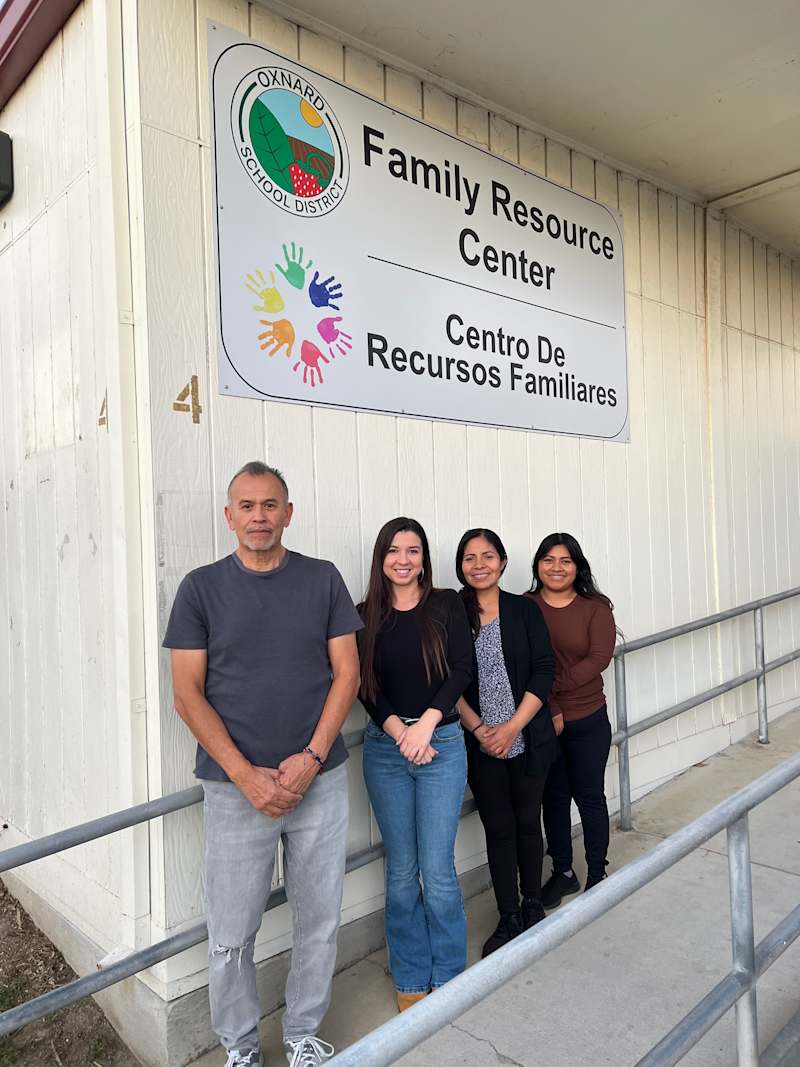 Four staff members stand outside the Oxnard School District Family Resource Center building.