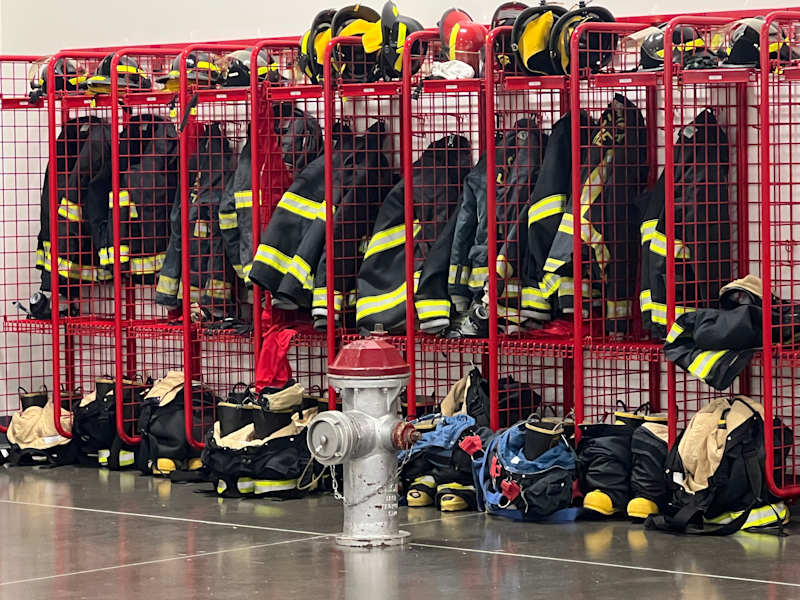 Firefighting gear in red cubbies