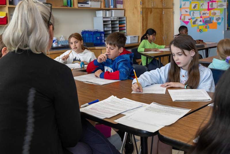 Students utilizing collaborative tech tools inside a stylized classroom environment at Ballantyne Elementary School.