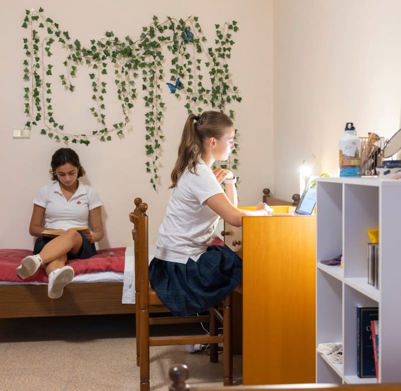 A student studying at a desk inside a CCI residence