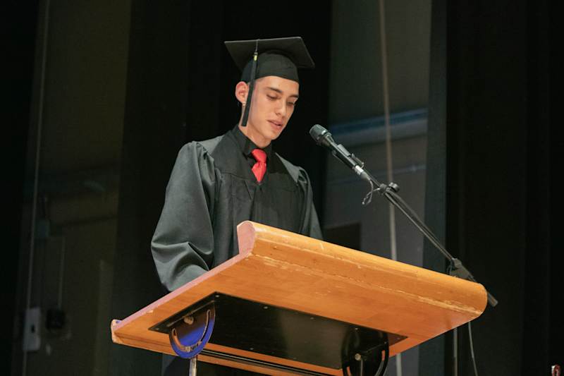 A CCI graduate speaking from the stage
