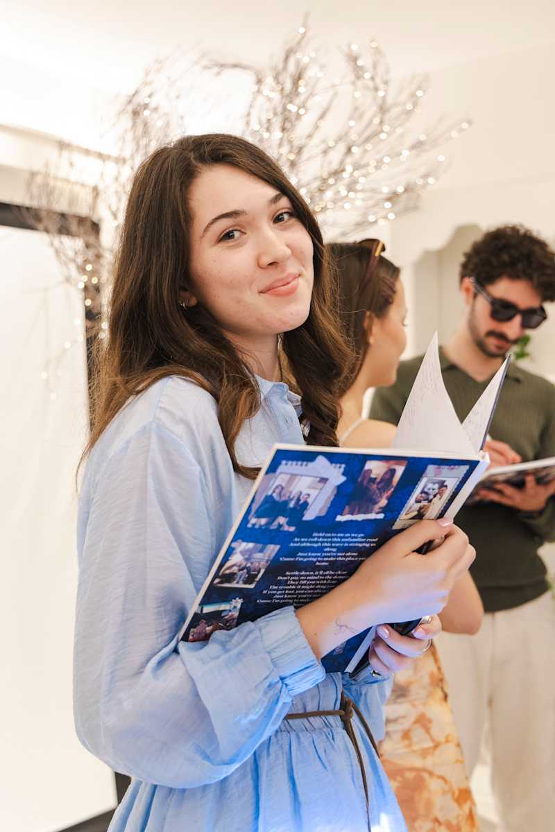 A student holding an open CCI yearbook